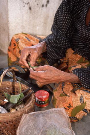 A woman prepares betel nuts