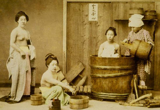 Three topless geishas bathe and clean themselves, ca 1880s
