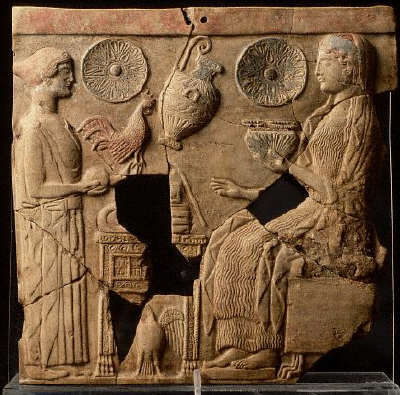 Persephone makes an offering of a cock in a scene from an ancient terracotta freize. 6th c B.C.