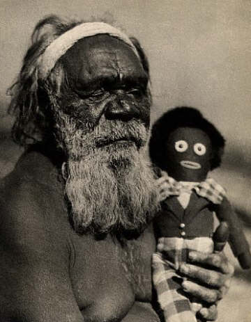 Australian Aborigine Hector McQuarrie holds a doll