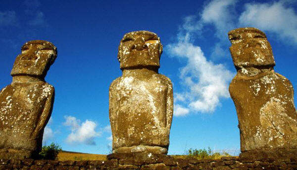 Three of the seven stone moai statues facing the sea at Ahu Akivi