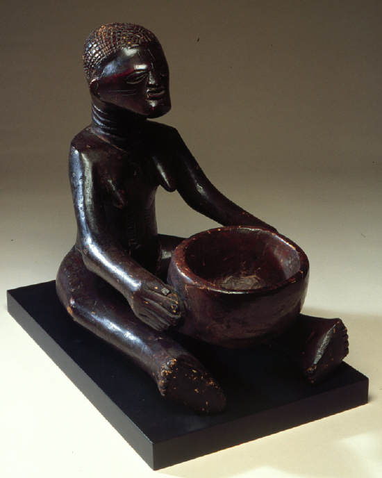 Female figure holding divination bowl. Songye