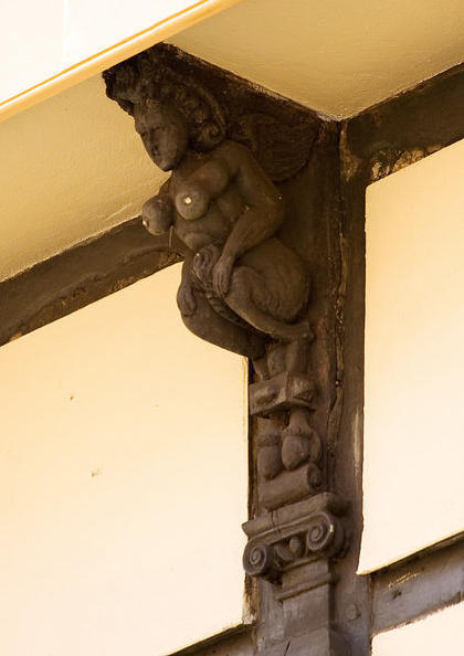 A 16th century wooden bracket is carved to represent a succubus