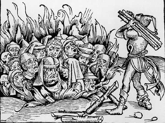 A man carries wood to a fire where Jews are burned alive, in a woodcut dating from 1495