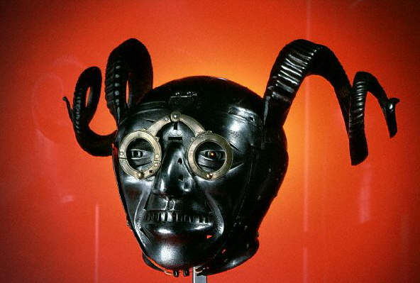 A gruesome-faced metal mask with twisted horns