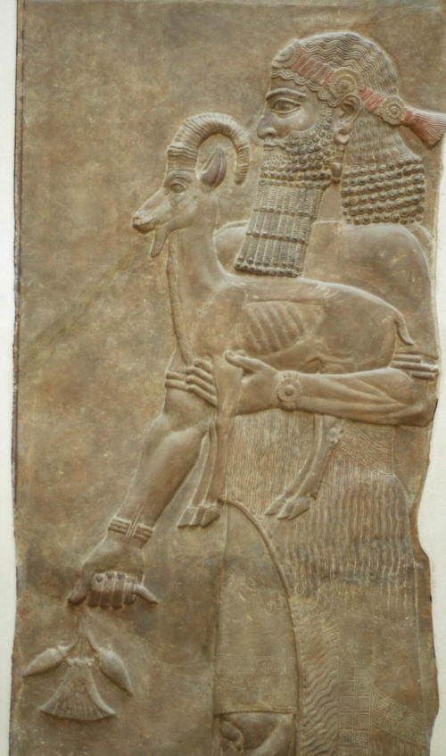 Assyrian Genie holding an ibex and a poppy flower