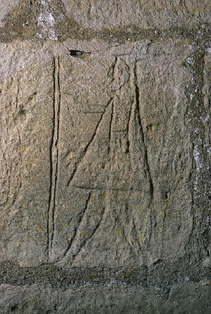 Graffiti depicting a pilgrim is scratched onto a church wall in Ecebrunne, France