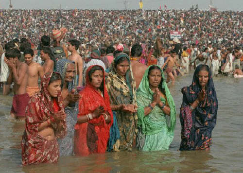 Women bathing in the Ganges and praying to the sacred river