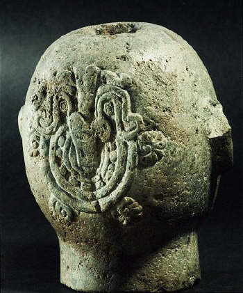 Aztec figure of Xipe Totec, the Flayed Lord, who is dressed in the skin of a sacrificial victim