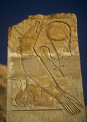 Horus as a hawk, wearing the combined crown of Upper and Lower Egypt, Above him is a snake with a sun-disk.