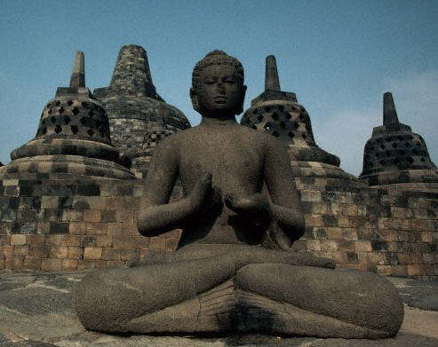 Buddha Statue Amid Bell-Shaped Stupas at Candi Borobudur