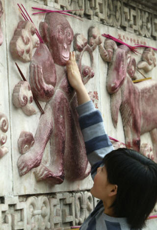 Woman Touching a Chinese Astrological Symbol