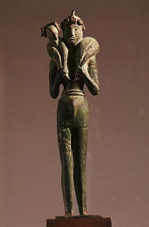 A votary carries a lamb on his shoulders. The figure is bronze and dates from the Minoan civilization of Crete